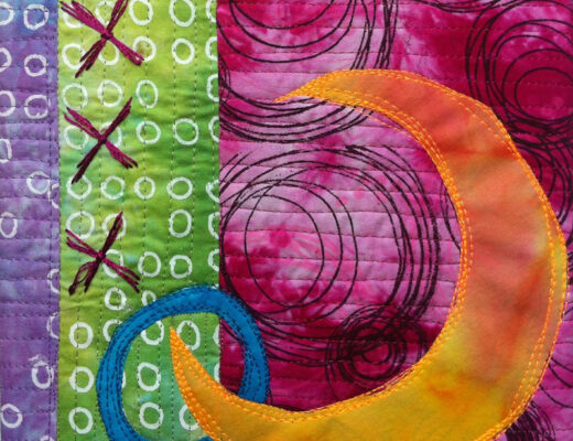 textile art with orange crescent surrounded by pink, green, and purple circles and embroidered X