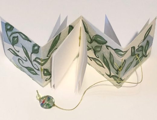 tiny accordion book with leaves painted not eh cover