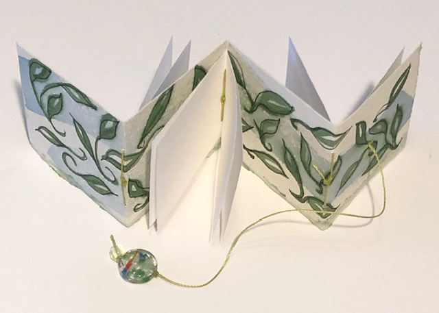 tiny accordion book with leaves painted not eh cover