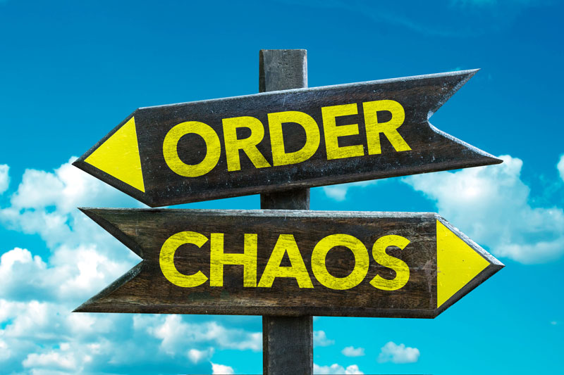sign post with the words order pointing one way and chaos pointing the opposite direction